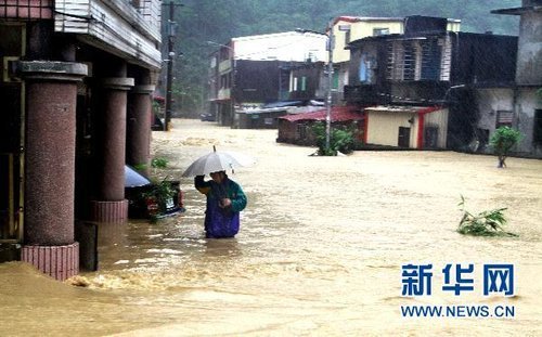 10月21日，臺灣宜蘭縣蘇澳地區(qū)居民在洪水中艱難出行。新華社發(fā) 